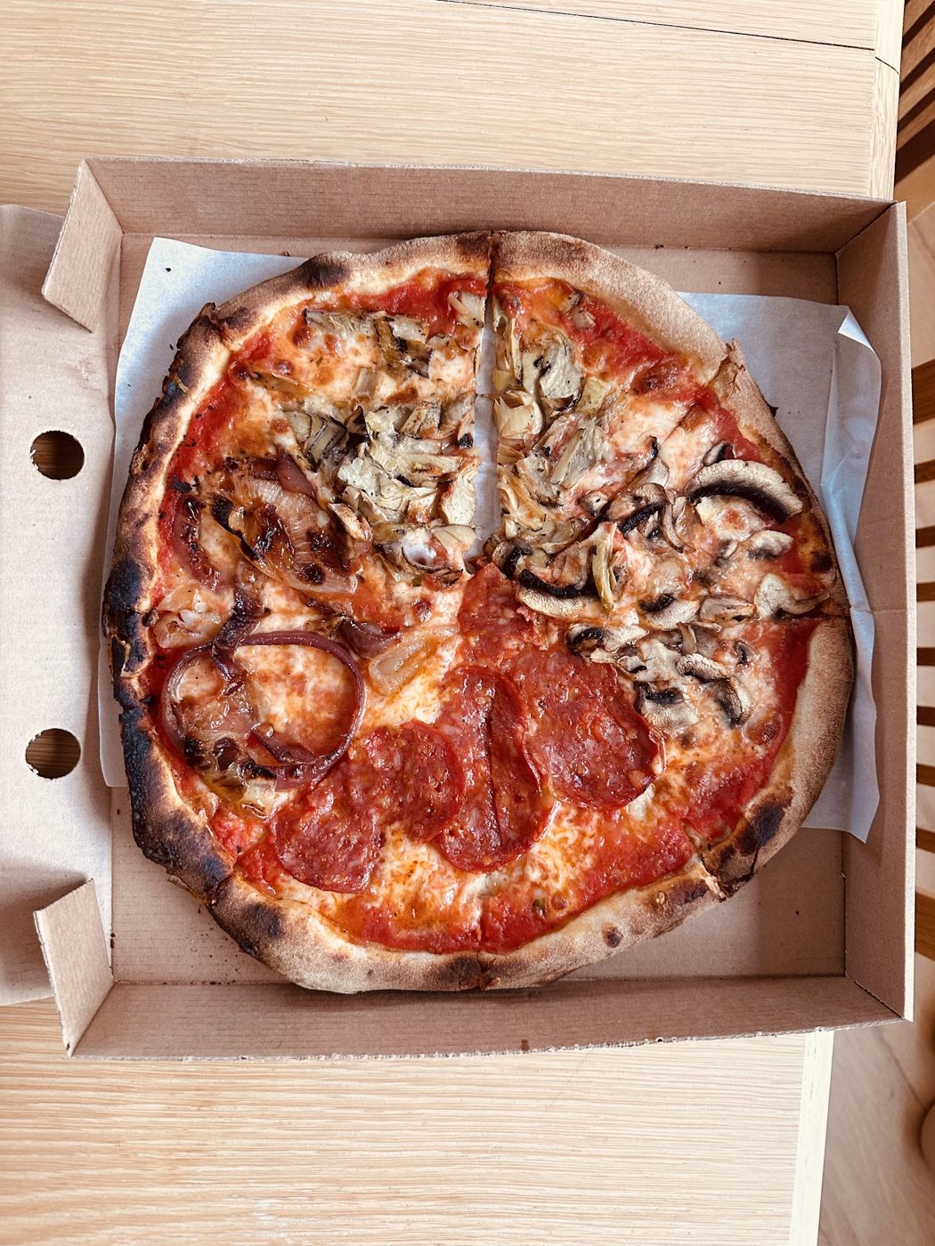 A pizza in a takeaway box