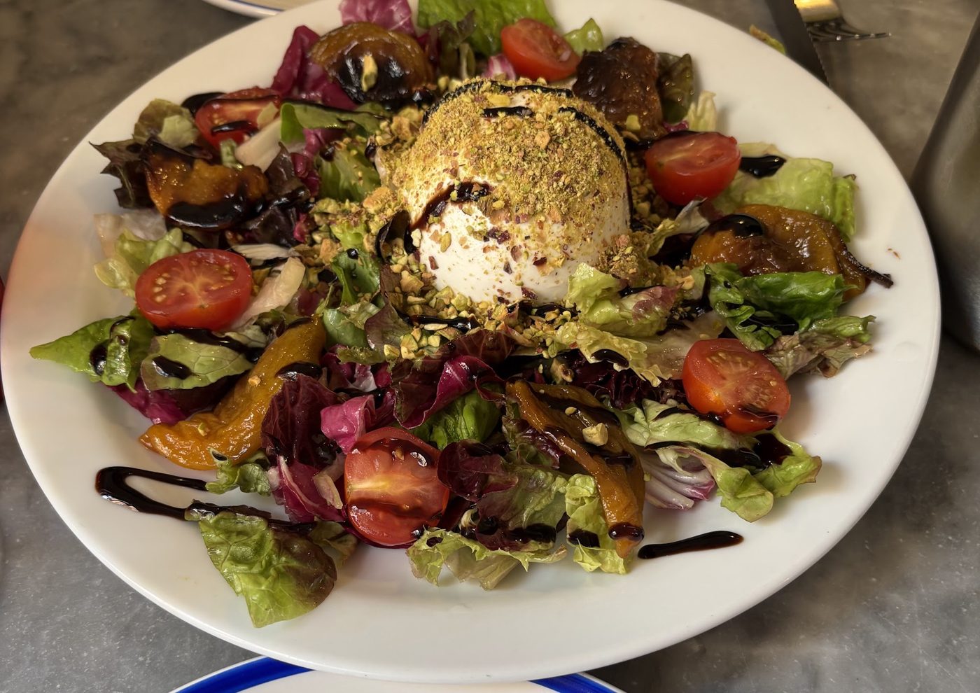 A salad topped with burrata