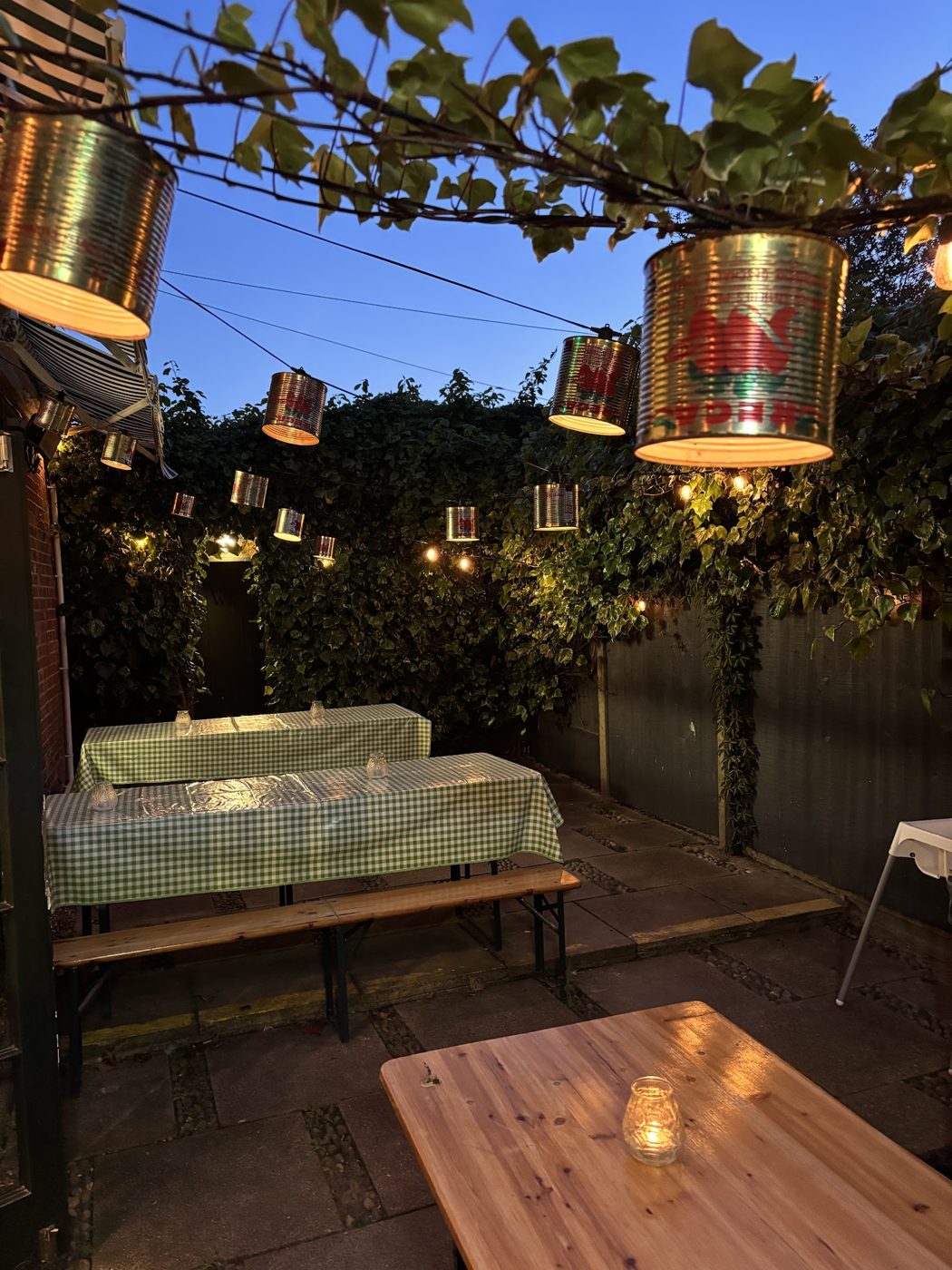 The garden at dusk, with lanterns and tables