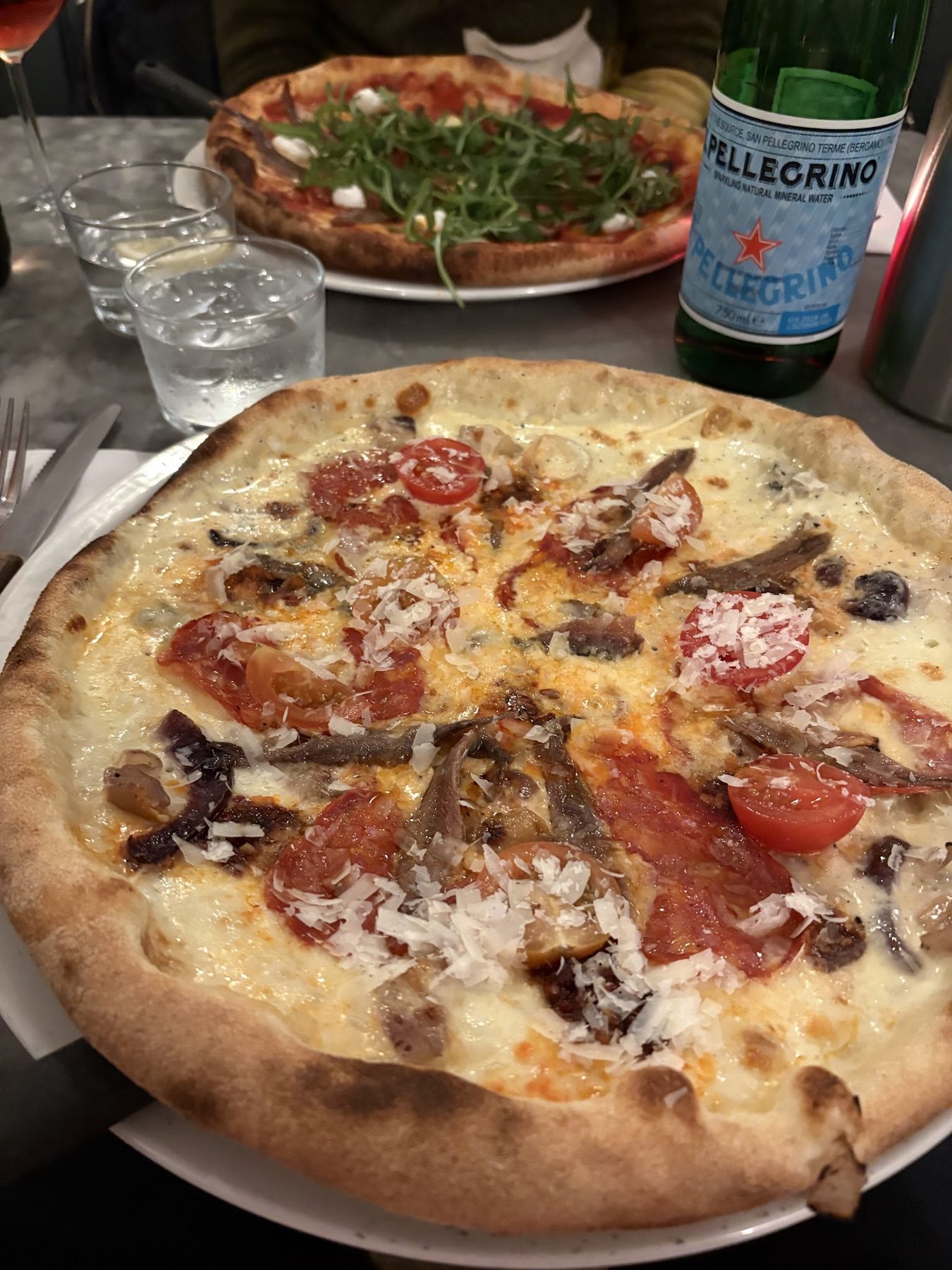 A pizza with salami and mushrooms